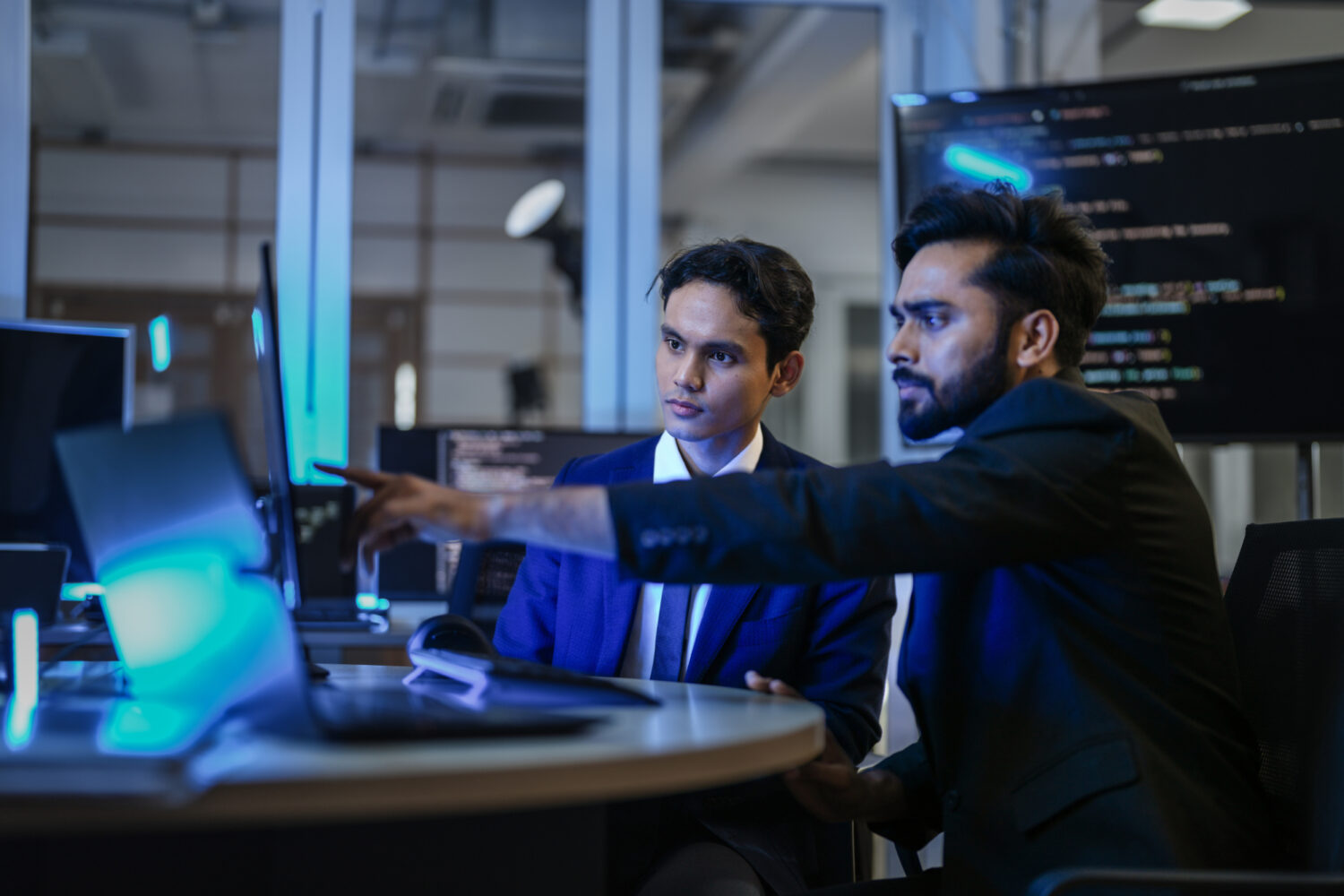 A diverse team of AI developers shares a successful moment in th