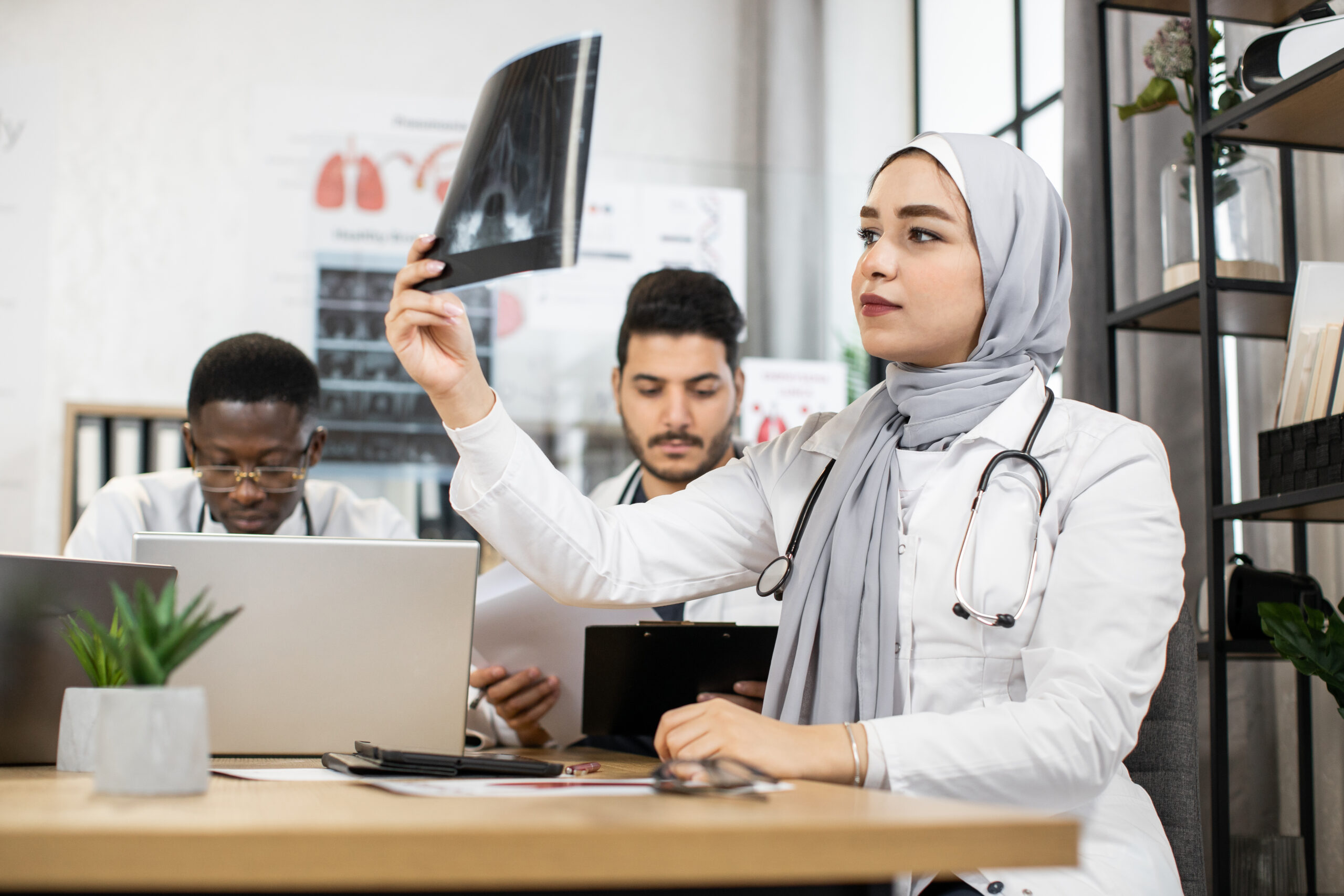 International doctors discussing results of x ray scan