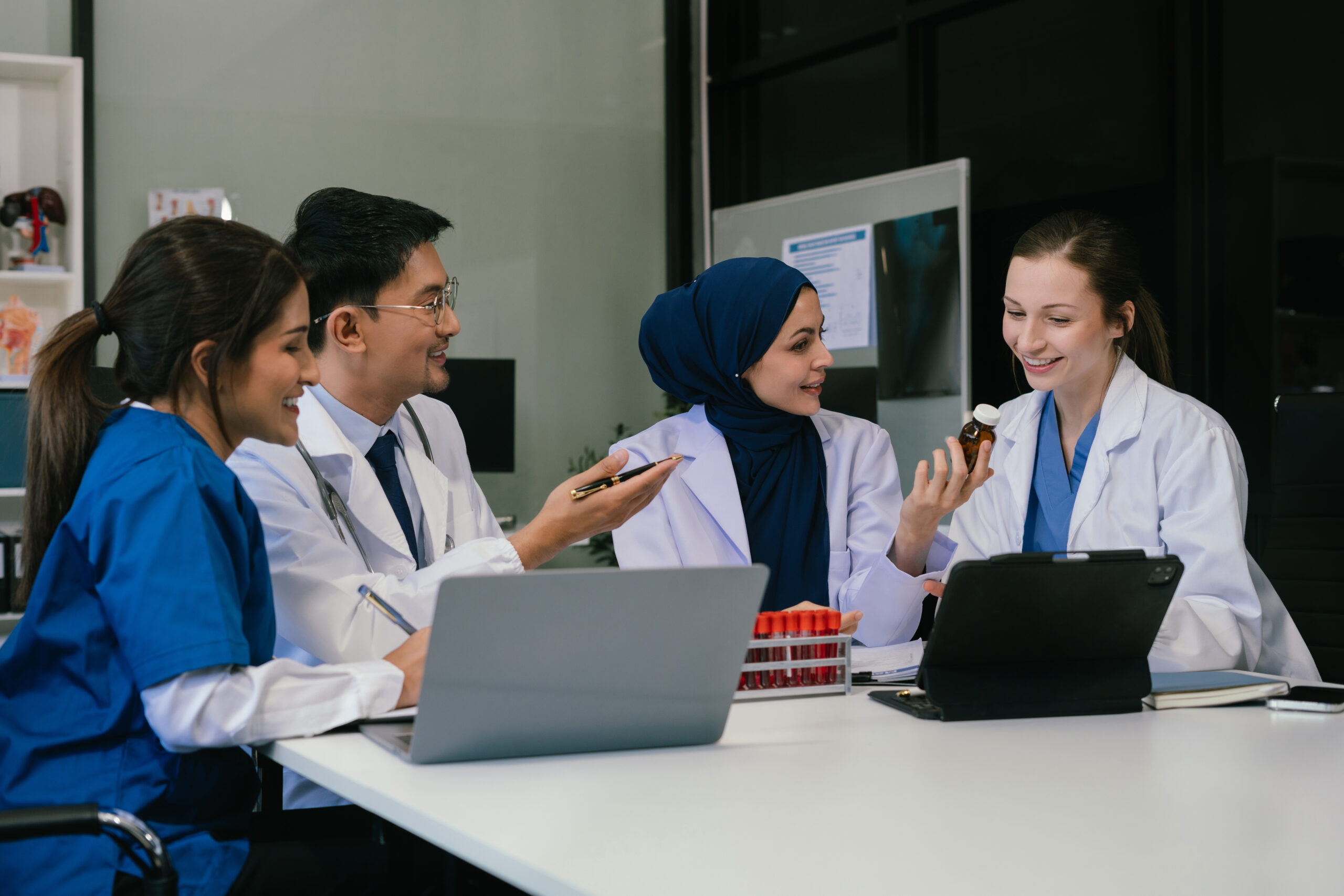 Medical, meeting and laptop for team in office in discussion, br